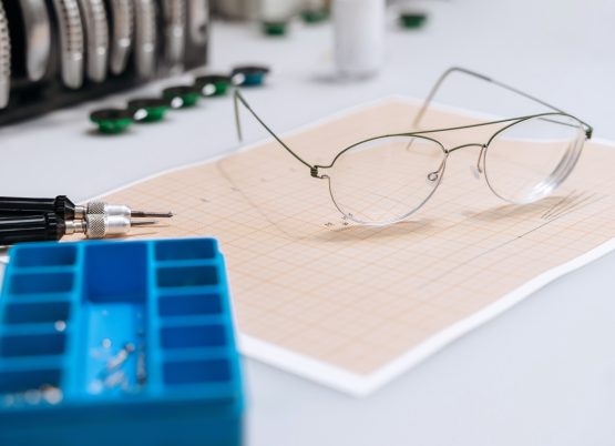 Closeup of optician repairing equipment for fixing eyeglasses